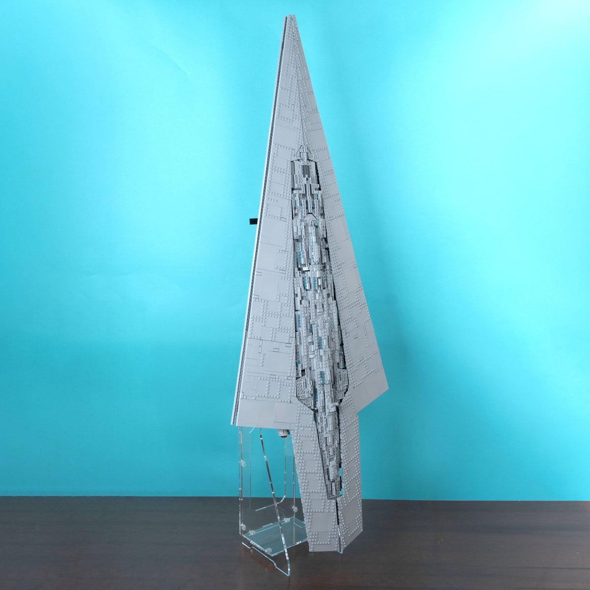 A large assembled lego 75457 Star Wars Star Destroyer, standing on a clear acrylic display made from the strongest acrylic.